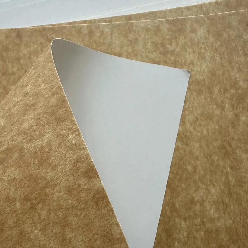 A sheet of kraft board with a white coated front and a natural brown kraft reverse.