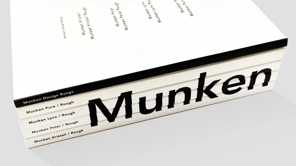 A variety of Munken Collection paper swatches showing different weights and shades.