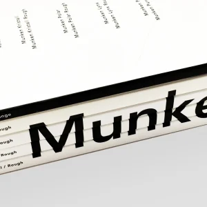 A variety of Munken Collection paper swatches showing different weights and shades.